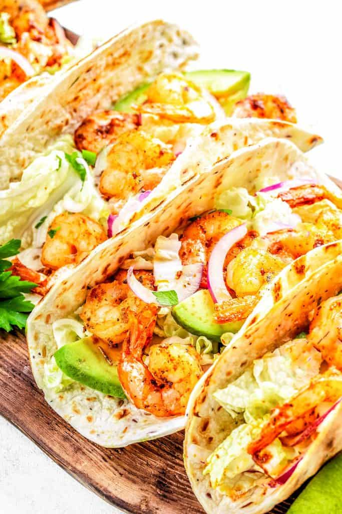 Seafood tacos with slaw, red onion and avacado