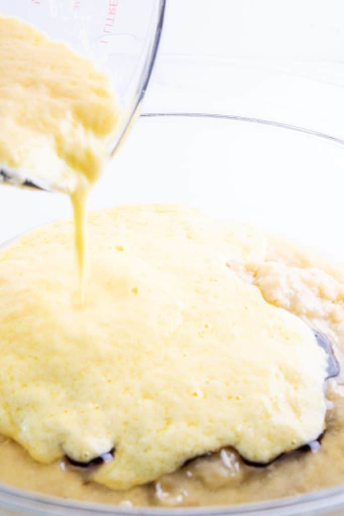 wet ingredients being poured into dry ingredients