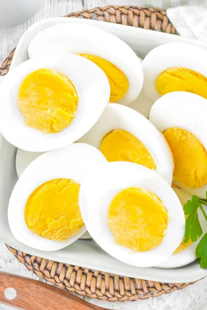 above view of halved hard boiled eggs in a bowl