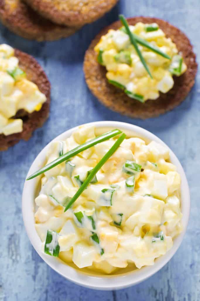 Egg salad with chives on a wooden background. Selective focus.