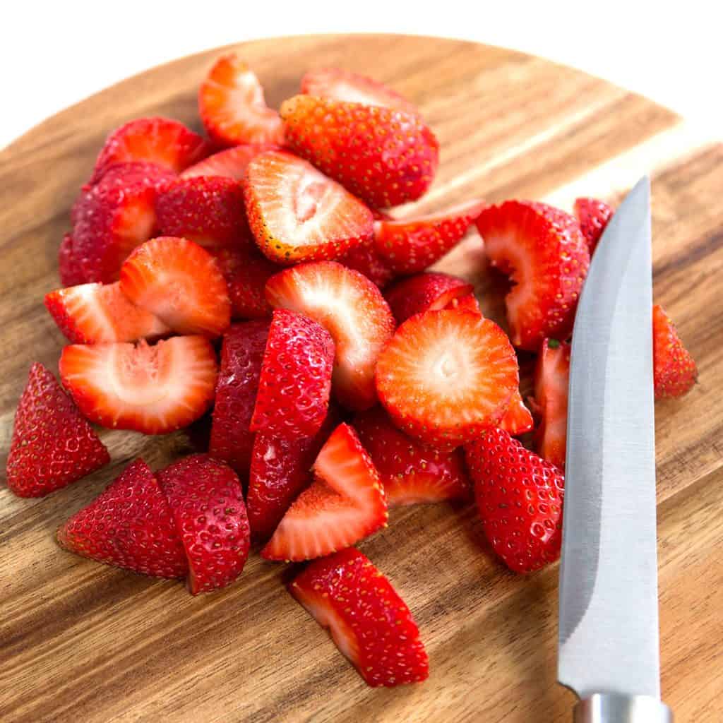 Slices of strawberries on chopping board