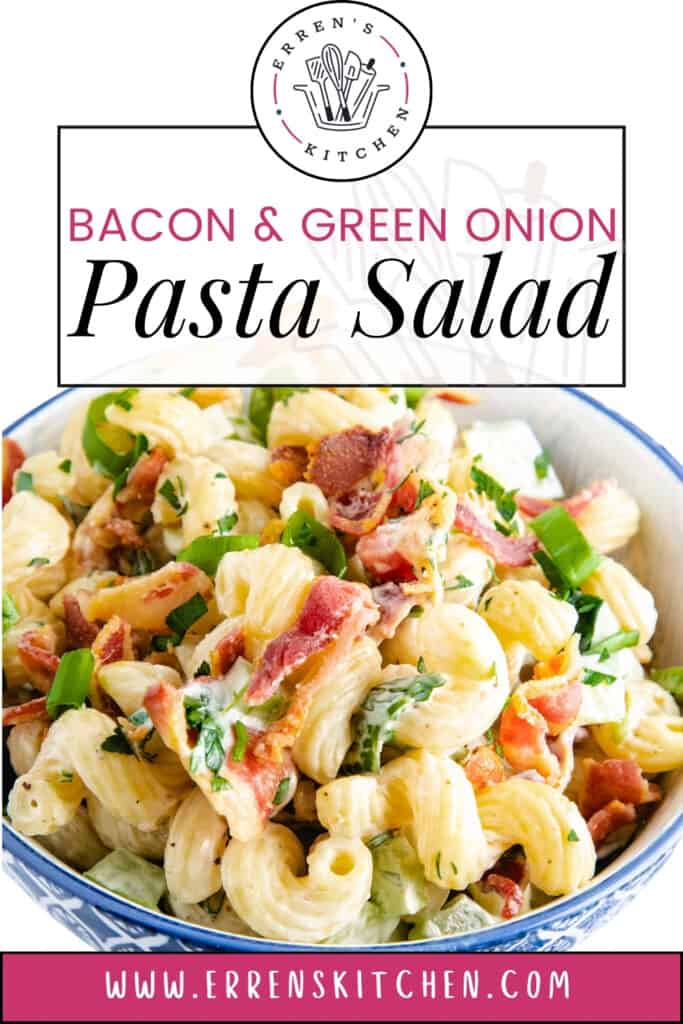 A photo of a bowl of pasta salad with curly pasta, chopped bacon and green onions