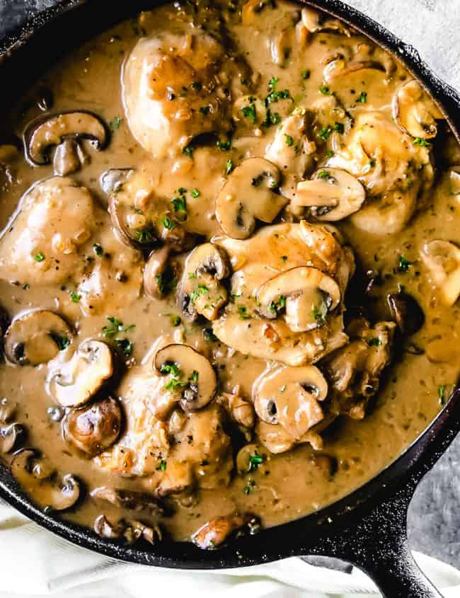 A pan of Chicken with mushrooms in a brown sauce