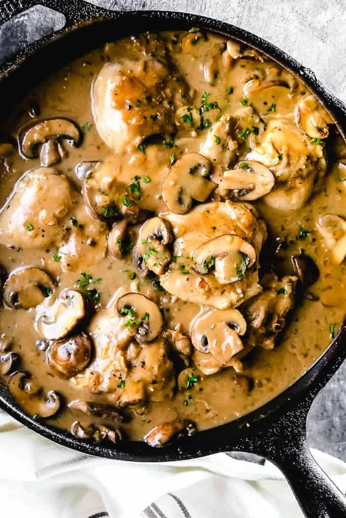A pan of Chicken with mushrooms in a brown sauce