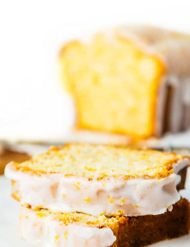 slices of glazed lemon pound cake with the cake in the background