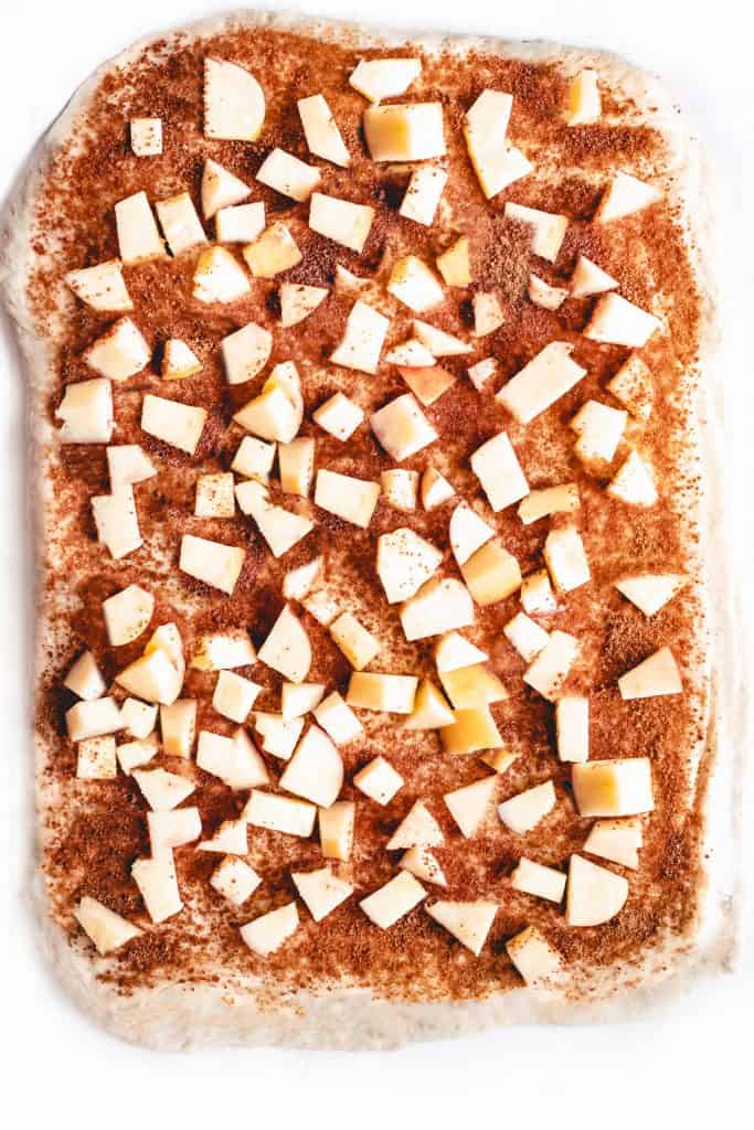 apple pieces on top of cinnamon sugar covered dough.