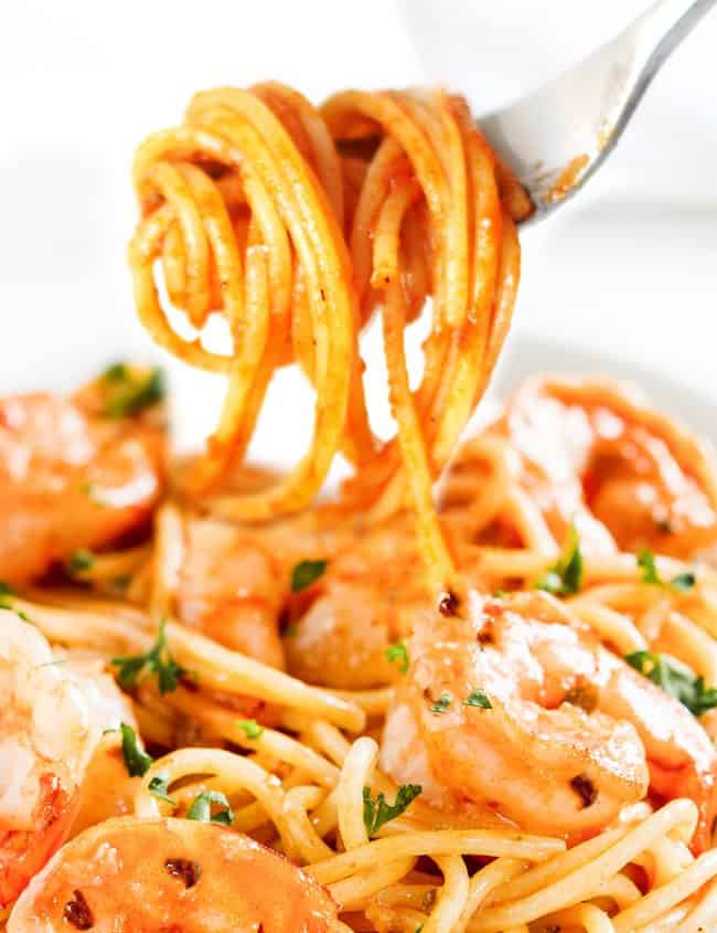 shrimp and spaghetti twirled on a fork