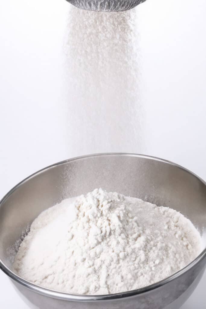 the dry ingredients being sifted into a bowl.