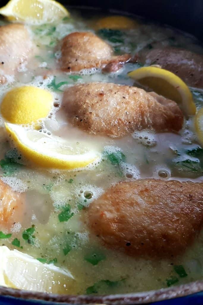 stock with chicken and lemon in a pan