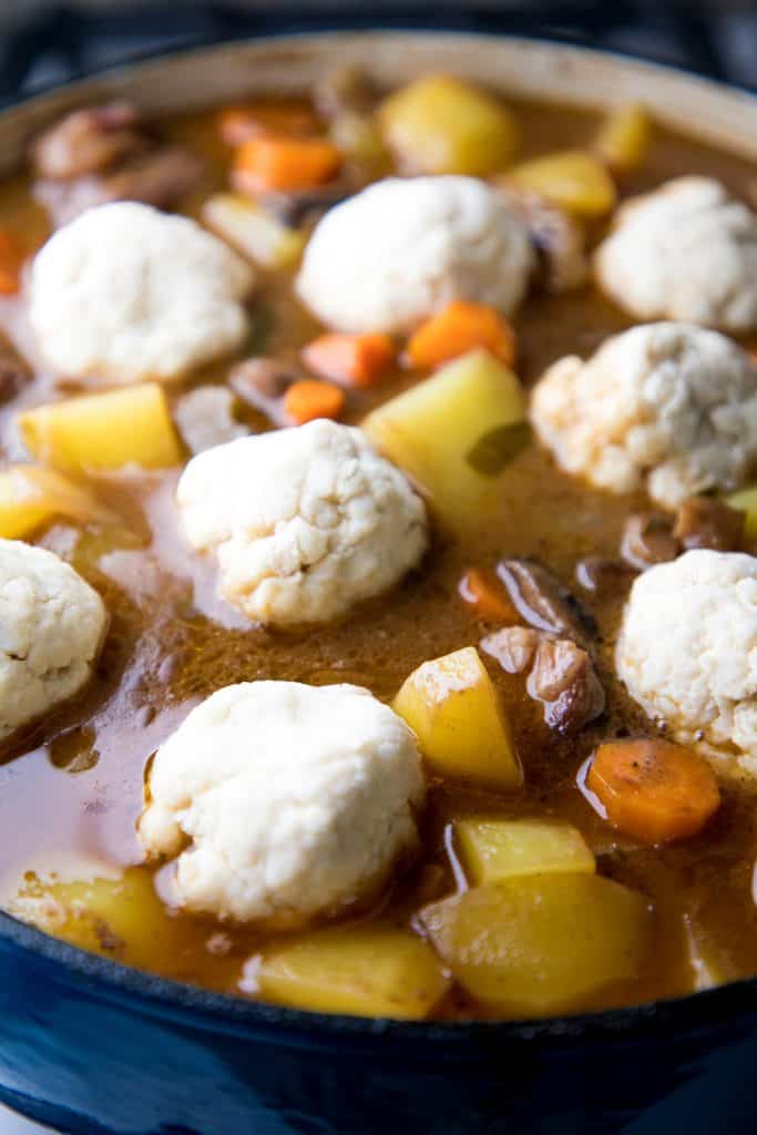 raw dumplings placed on stew