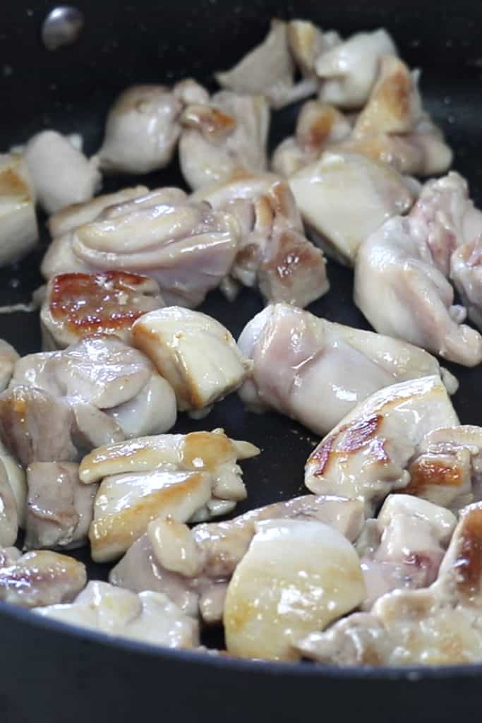 chicken frying in a pan