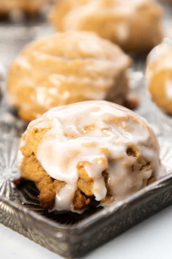Spiced German cookies {Pfeffernüsse} covered in an icing glaze