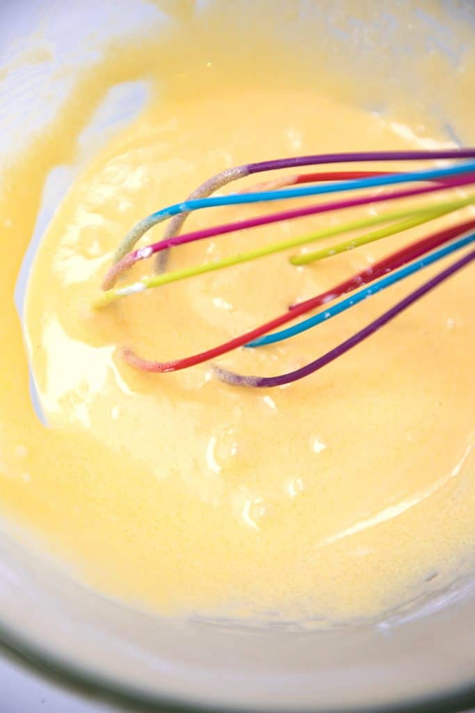 the egg mixture being whisked in a bowl