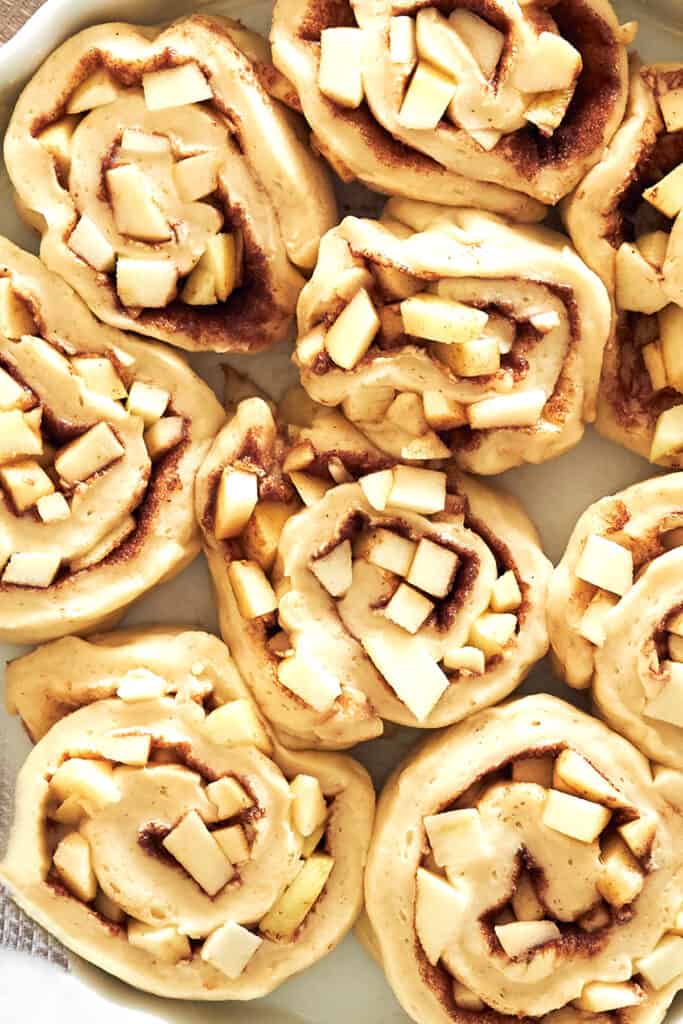 ccinnamon roll dough filled with apples in a pan 