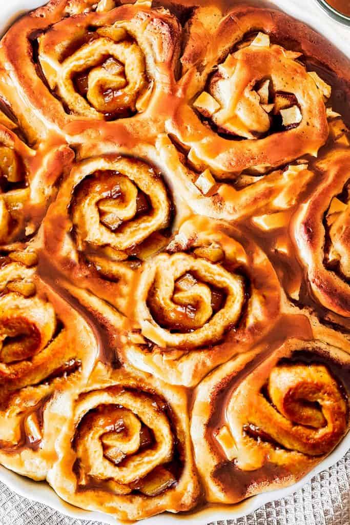 A close up of the freshly baked delicious Cinnamon Rolls With Apple Pie Filling in a pan