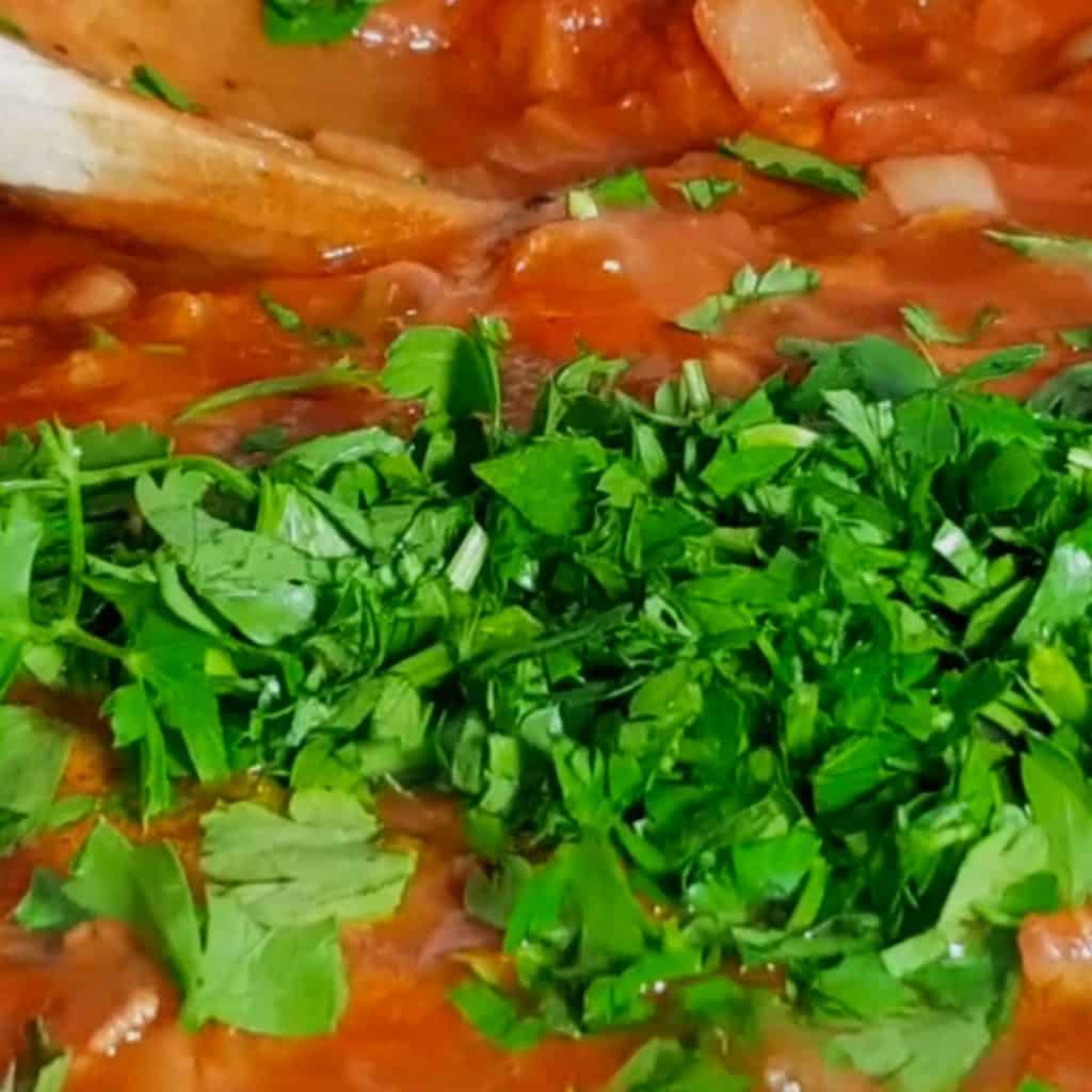 parsley added to the pan with the Spicy Shrimp Spaghetti