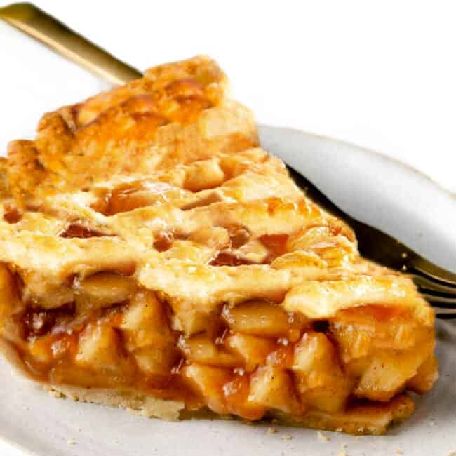 a slice of apple pie with a fork on a plate