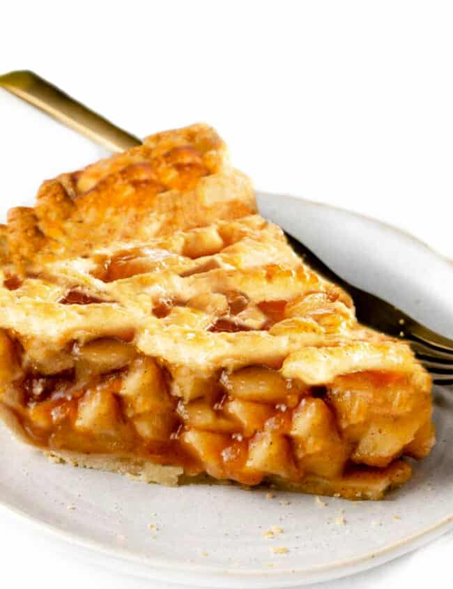 a slice of apple pie with a fork on a plate