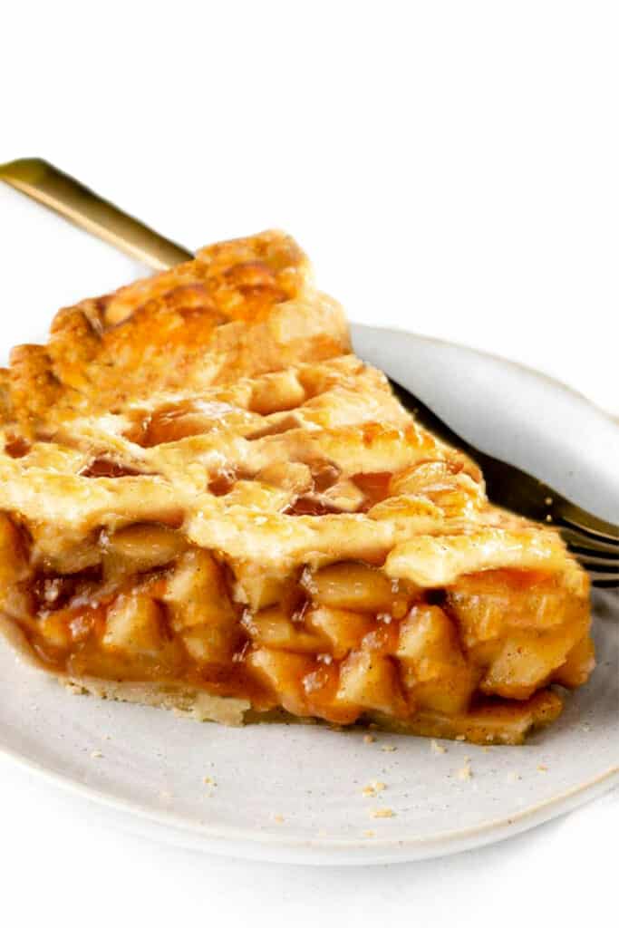 a slice of apple pie with a fork on a plate