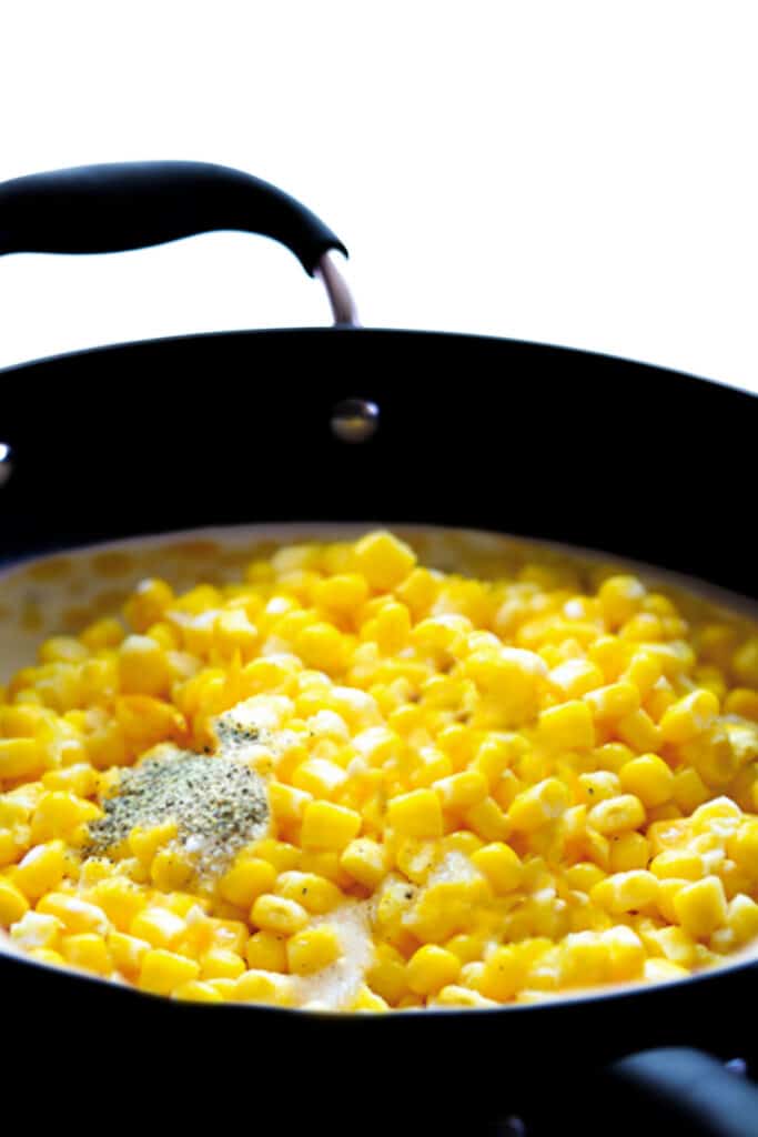 cream, corn and pepper in a pan
