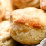 a close up of a freshly baked Buttermilk Biscuits in a baskey