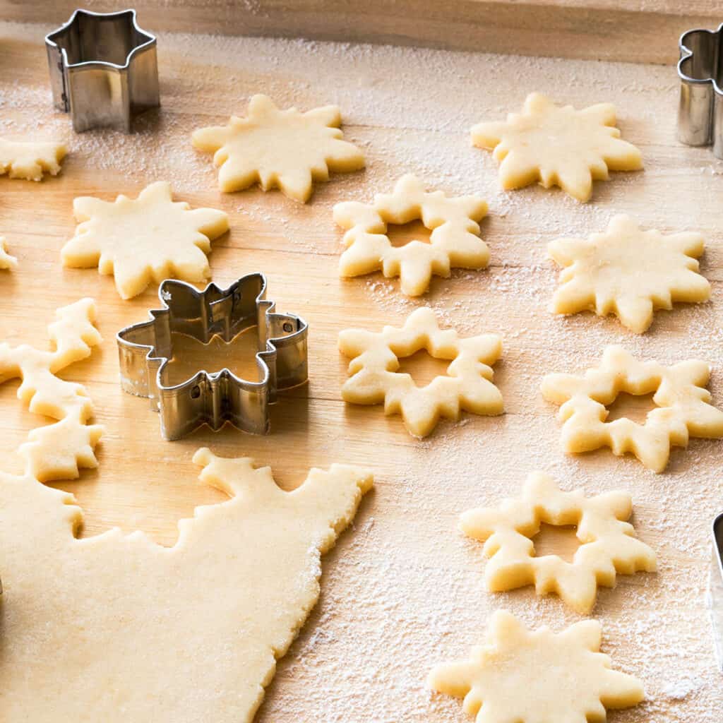 dough cut into snowflake shapes