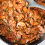 overhead shot of mushrooms in a tomato sauce