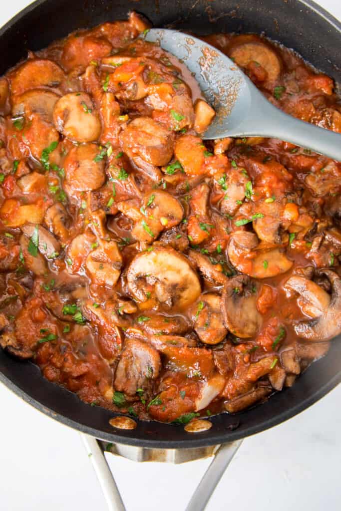 overhead shot of mushrooms in a tomato sauce