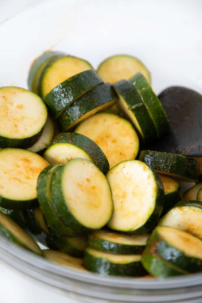 zucchini slices tossed in oil and seasoned salt
