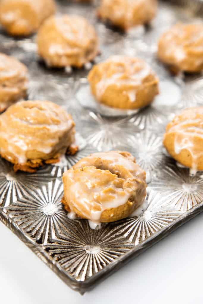 spiced German cookies on a cookie sheet topped with glaze
