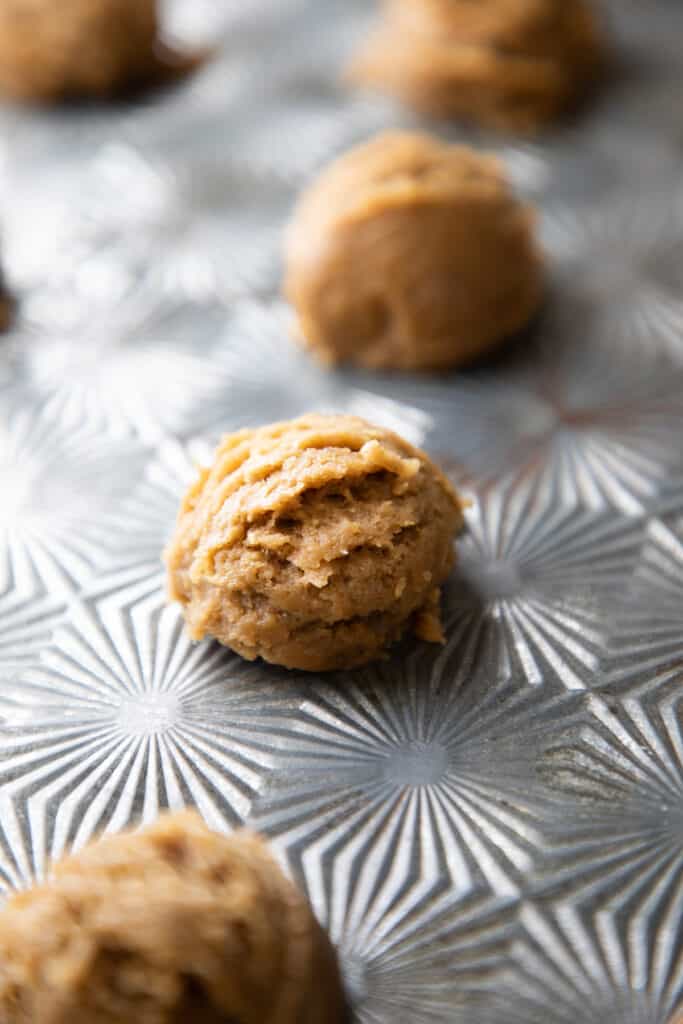 mounds of cookie dough on a baking sheet