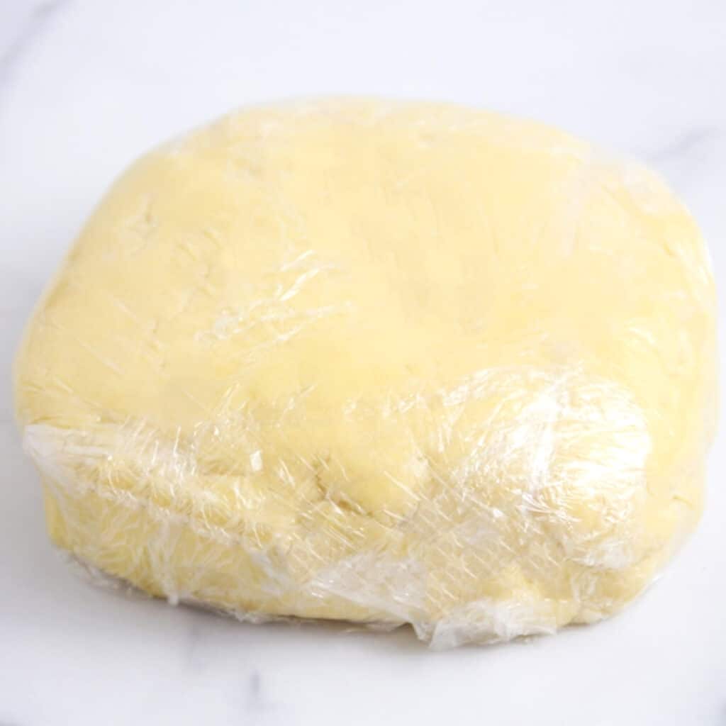 the dough wrapped in plastic wrap