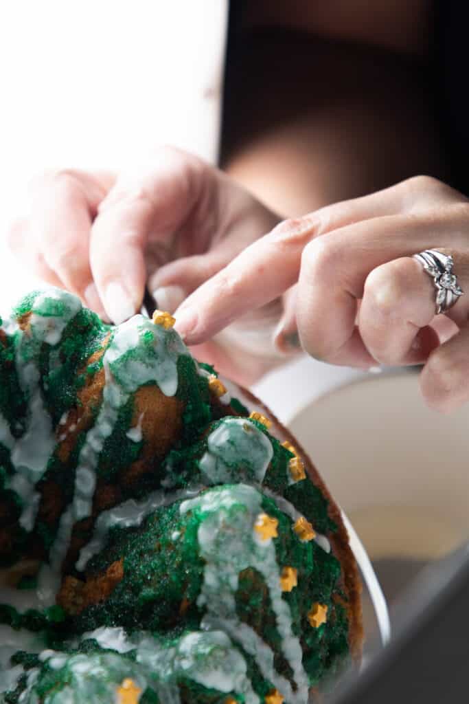 decorations being placed on the finished cake