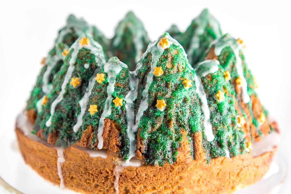 a bundt cake decorated with icing to look like Christmas trees