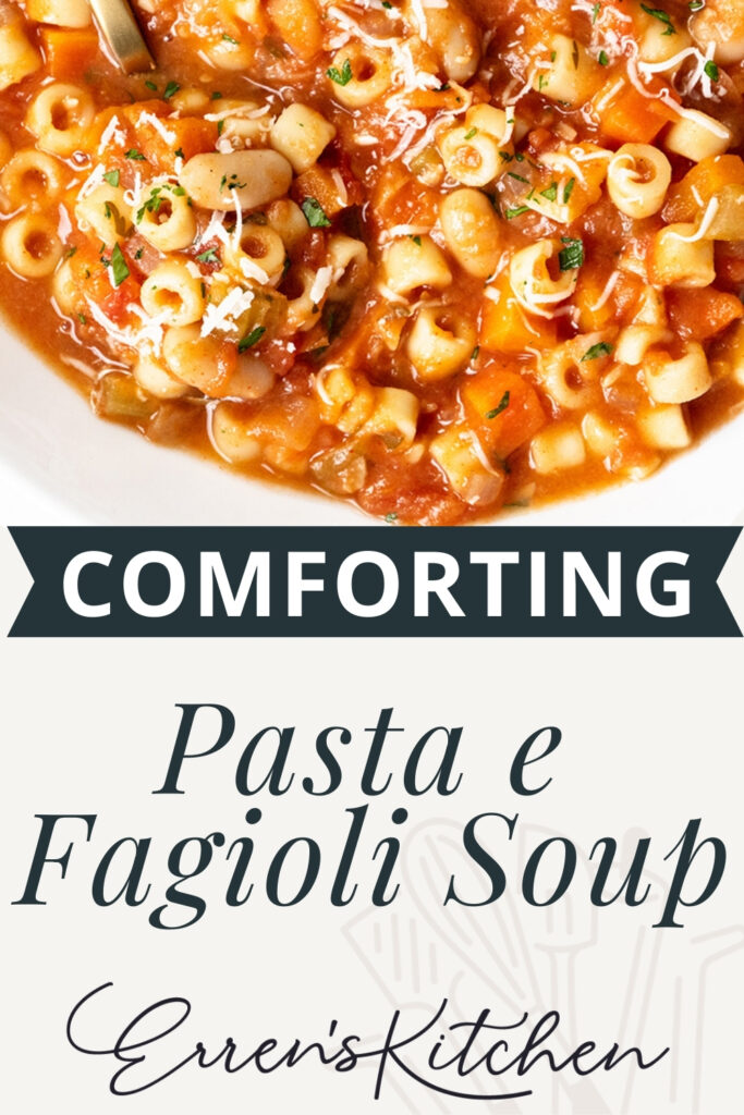 A close-up of a bowl of hearty Pasta E Fagioli Soup, topped with herbs and shredded cheese. Text on the image reads: "Comforting Pasta e Fagioli Soup Erren's Kitchen.