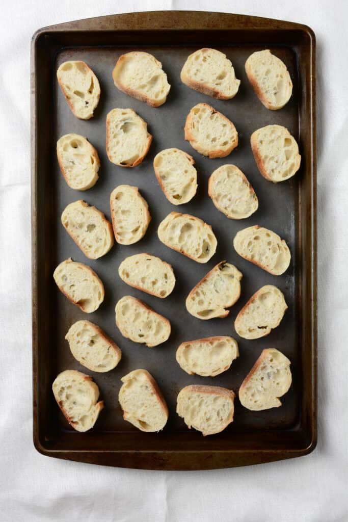 bread slices arranged on a baking sheet