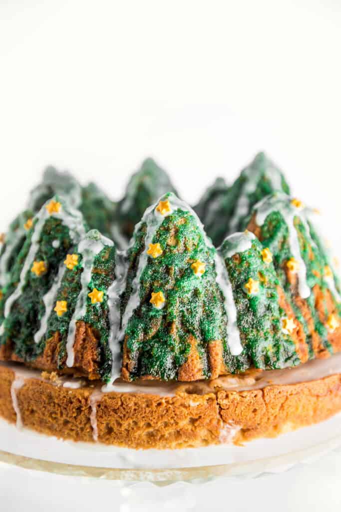 a bundt cake decorated with icing to look like Christmas trees
