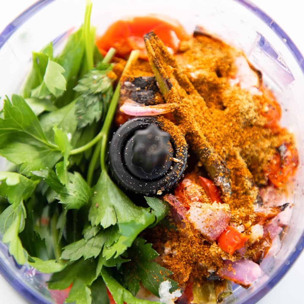 all of the marinade ingredients in the bowl of a food processor.