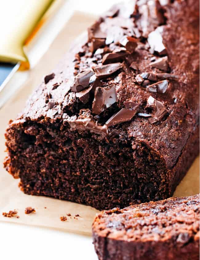 A sliced chocolate banana cake topped with chocolate chips