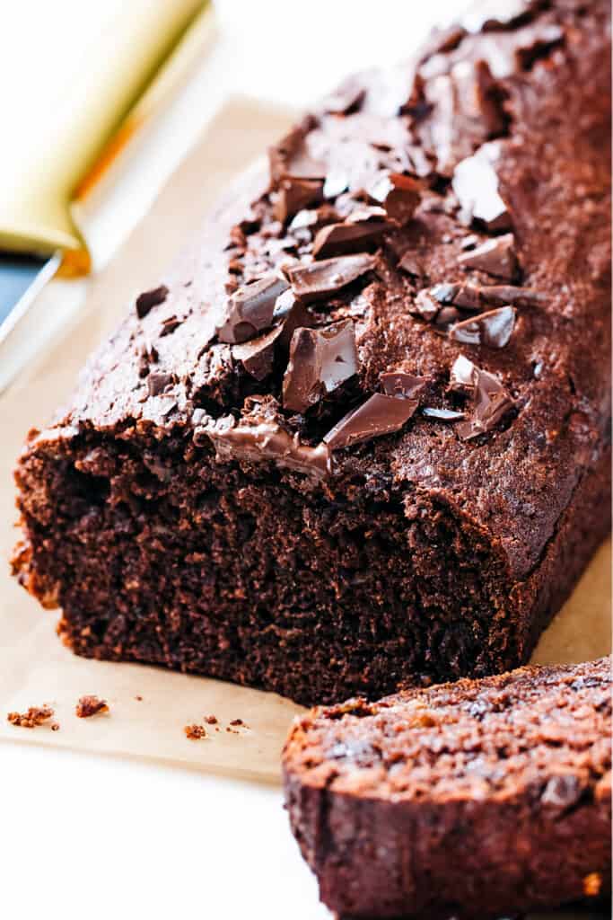 A sliced chocolate banana cake topped with chocolate chips