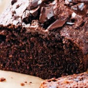 a close up image of A sliced chocolate banana cake topped with chopped chocolate.