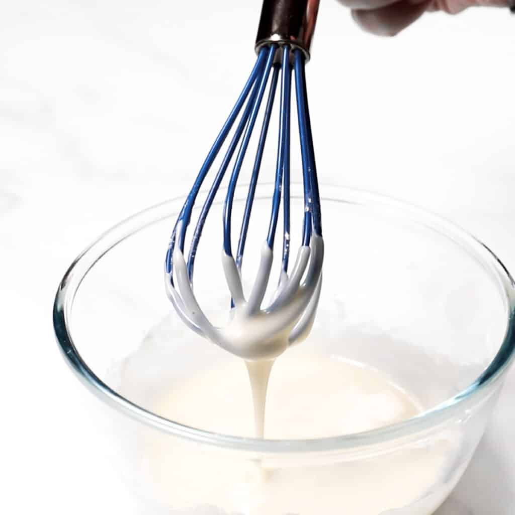 the glaze dripping from a whisk