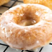 a close up image of a donut covered in an icing glaze