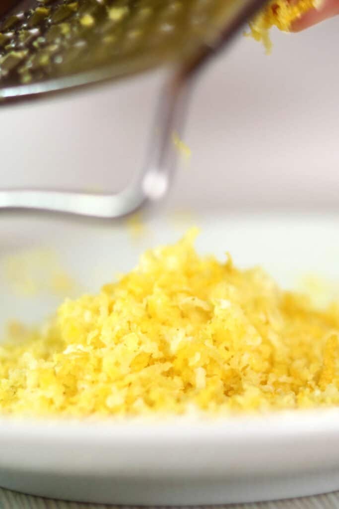 grating lemon zest onto a plate