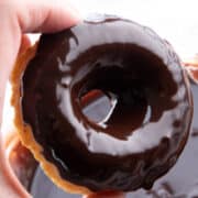 a donuts freshly dipped in chocolate glaze for donuts