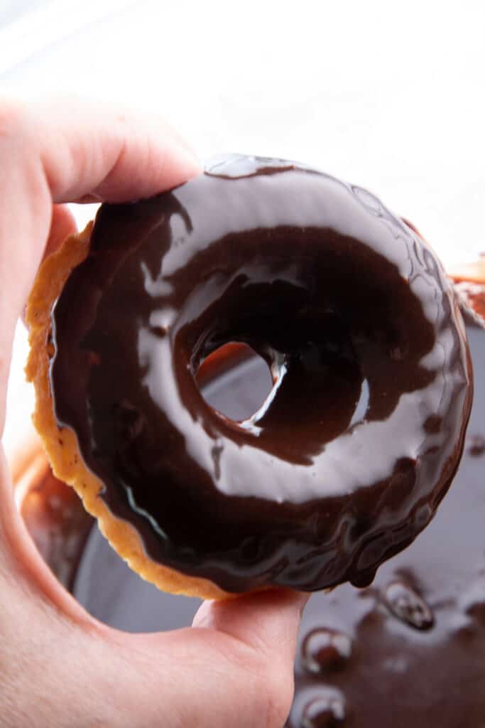 a donuts freshly dipped in chocolate glaze for donuts