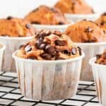 a batch of chocolate chip muffins cooling on a cooling rack