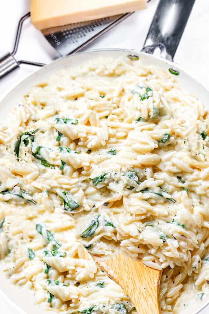 a pot of creamy orzo with spinach