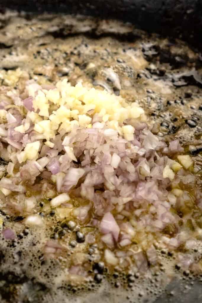 minced garlic and shallots in a pan