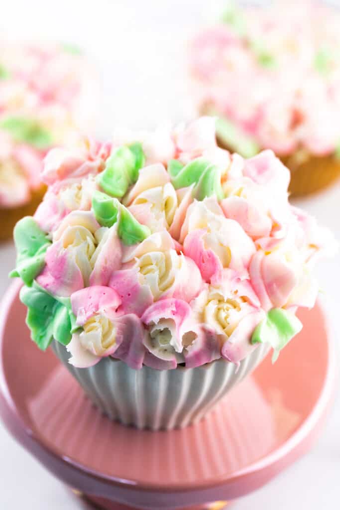 a cupcake covered in mini frosting roses